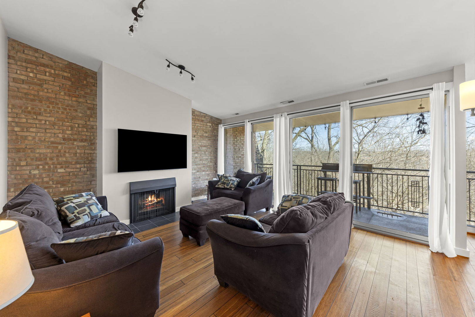 6010 Forest View Road, Unit 3A Lisle, IL 60532 - Photo 4 of 20 a living room with furniture a flat screen tv and a fireplace