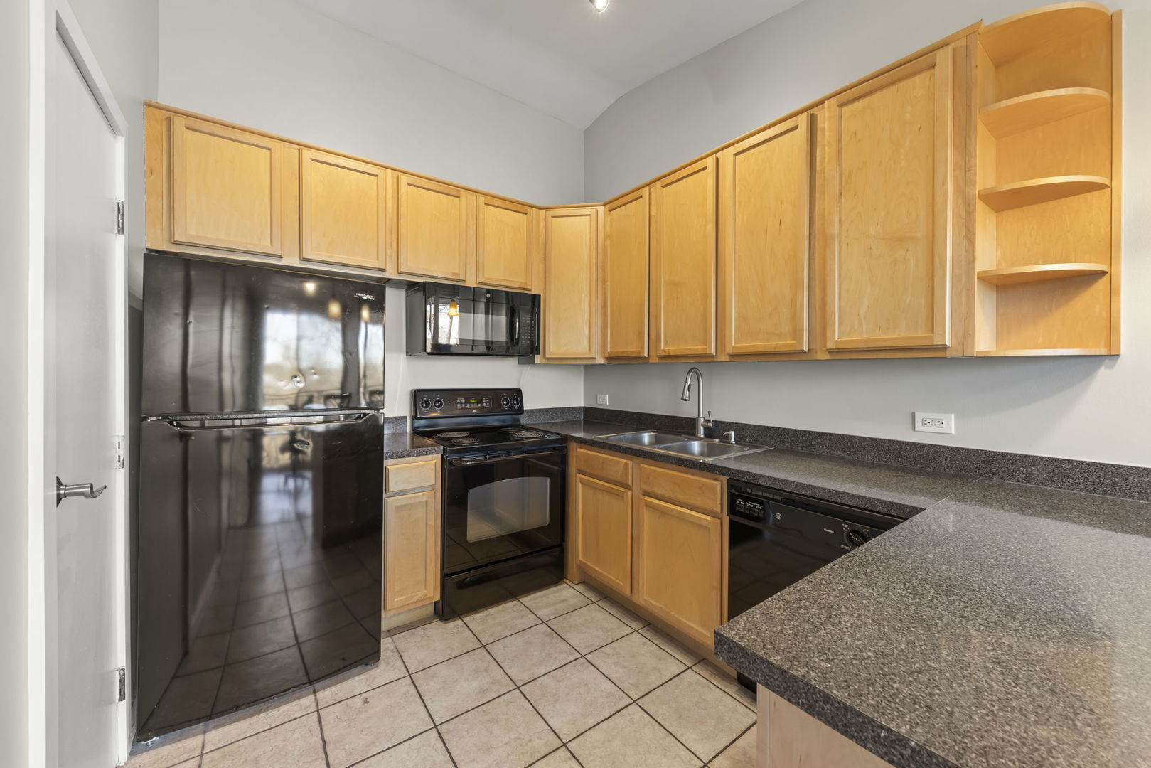 6010 Forest View Road, Unit 3A Lisle, IL 60532 - Photo 8 of 20 a kitchen with stainless steel appliances granite countertop a refrigerator a sink dishwasher a stove top oven and a dining table with wooden cabinet