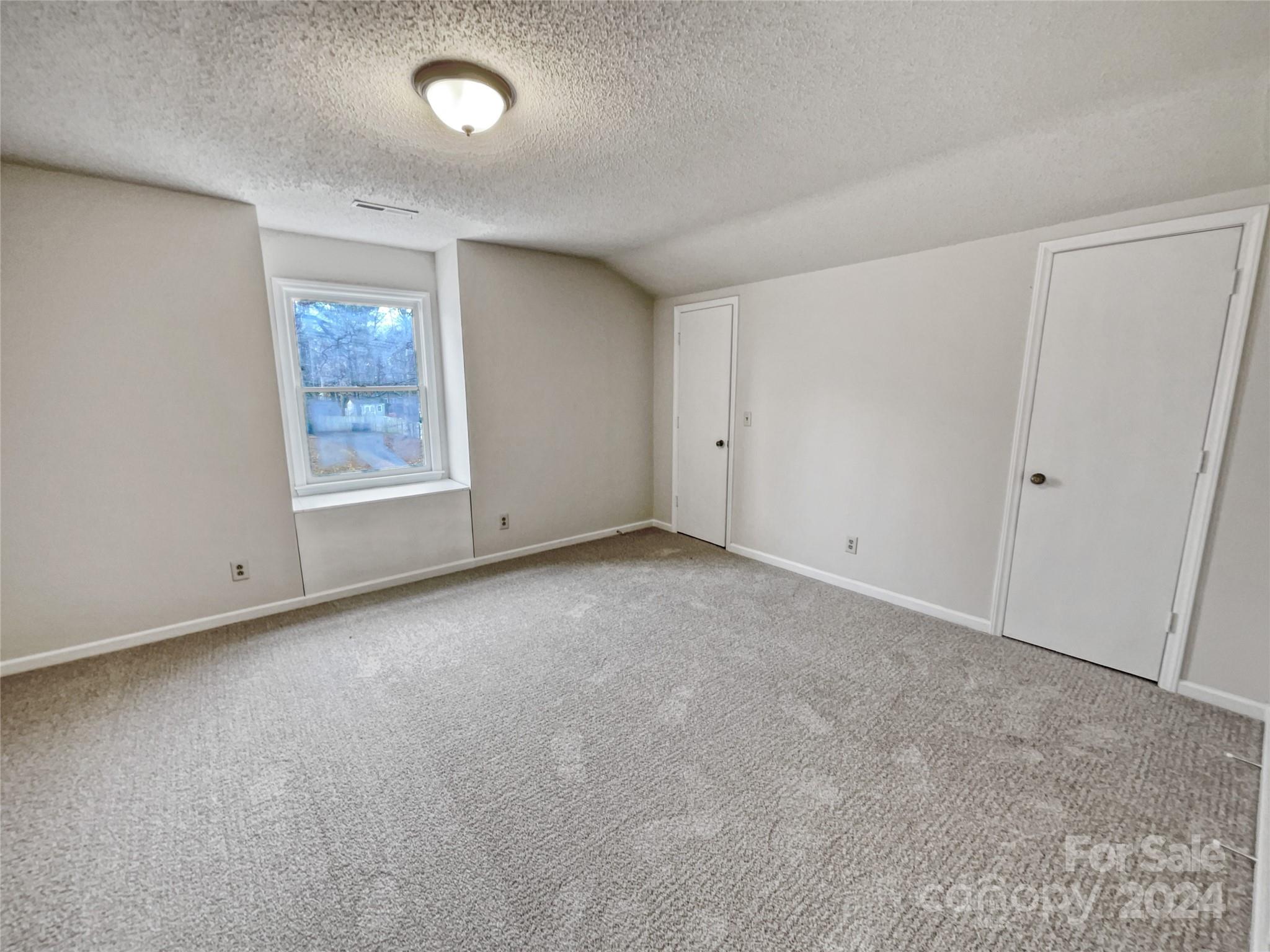 506 Ralph Handsel Boulevard Stanley, NC 28164 - Photo 13 of 18 an empty room with windows and closet