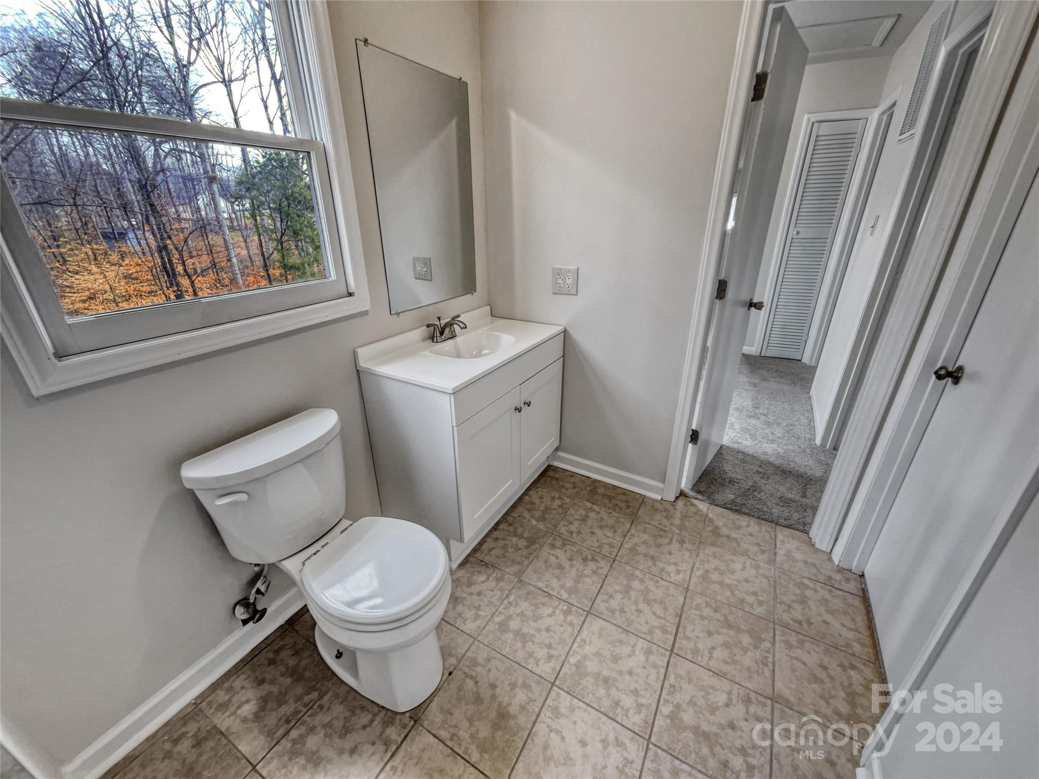 506 Ralph Handsel Boulevard Stanley, NC 28164 - Photo 15 of 18 a bathroom with a toilet sink and mirror