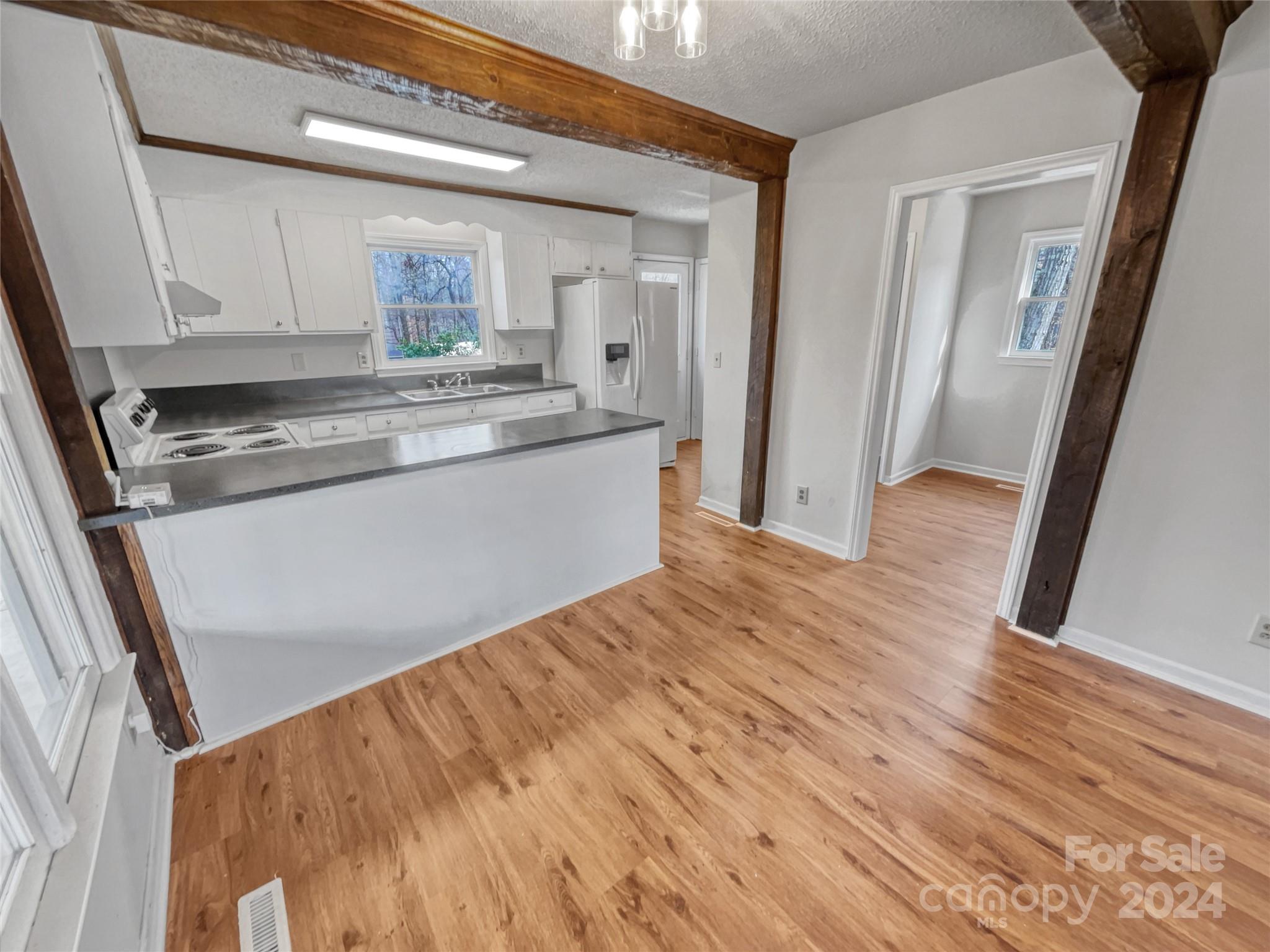 506 Ralph Handsel Boulevard Stanley, NC 28164 - Photo 8 of 18 a view of kitchen and wooden floor