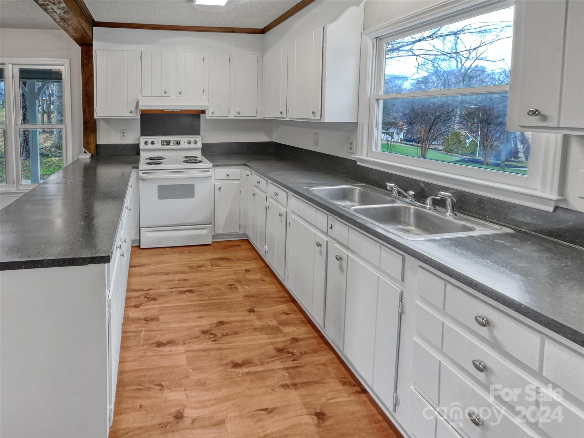 506 Ralph Handsel Boulevard Stanley, NC 28164 - Photo 9 of 18 a kitchen with stainless steel appliances granite countertop a stove a sink and white cabinets