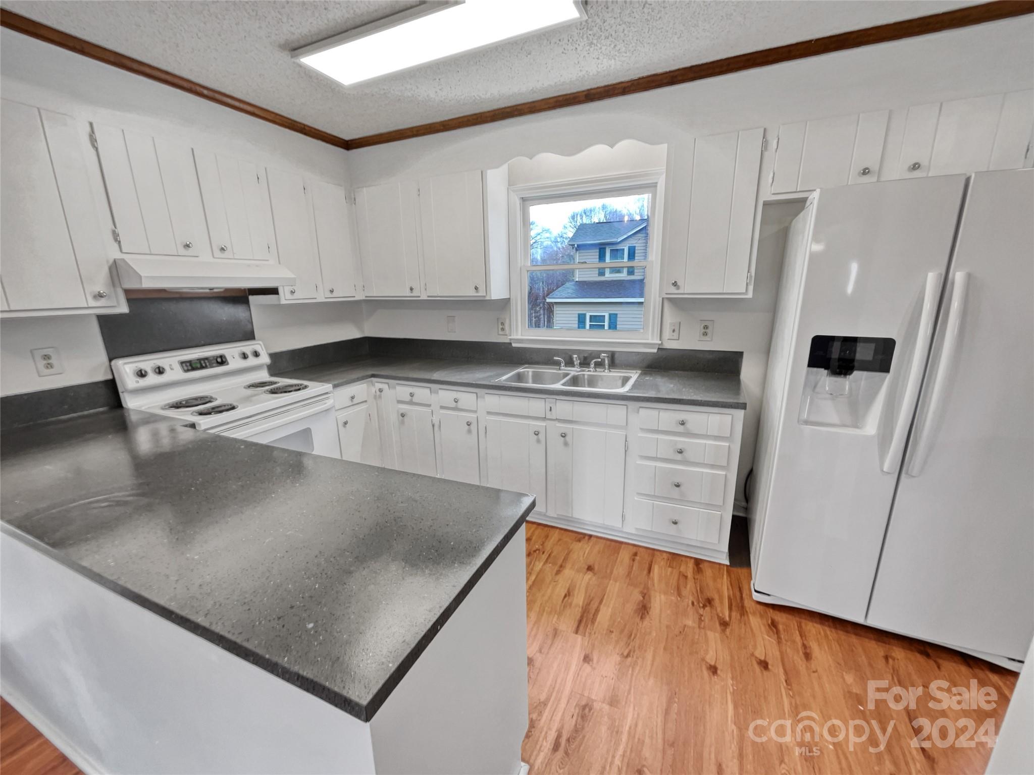506 Ralph Handsel Boulevard Stanley, NC 28164 - Photo 10 of 18 a kitchen with stainless steel appliances granite countertop a stove a sink and a refrigerator