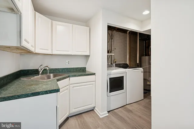 a kitchen with granite countertop white cabinets and white appliances