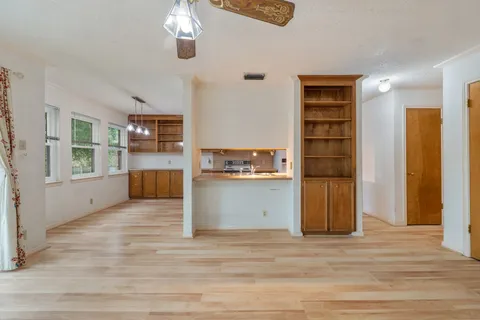a view of a room with wooden floor and windows