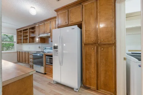 a spacious bedroom with a large bed and a chandelier
