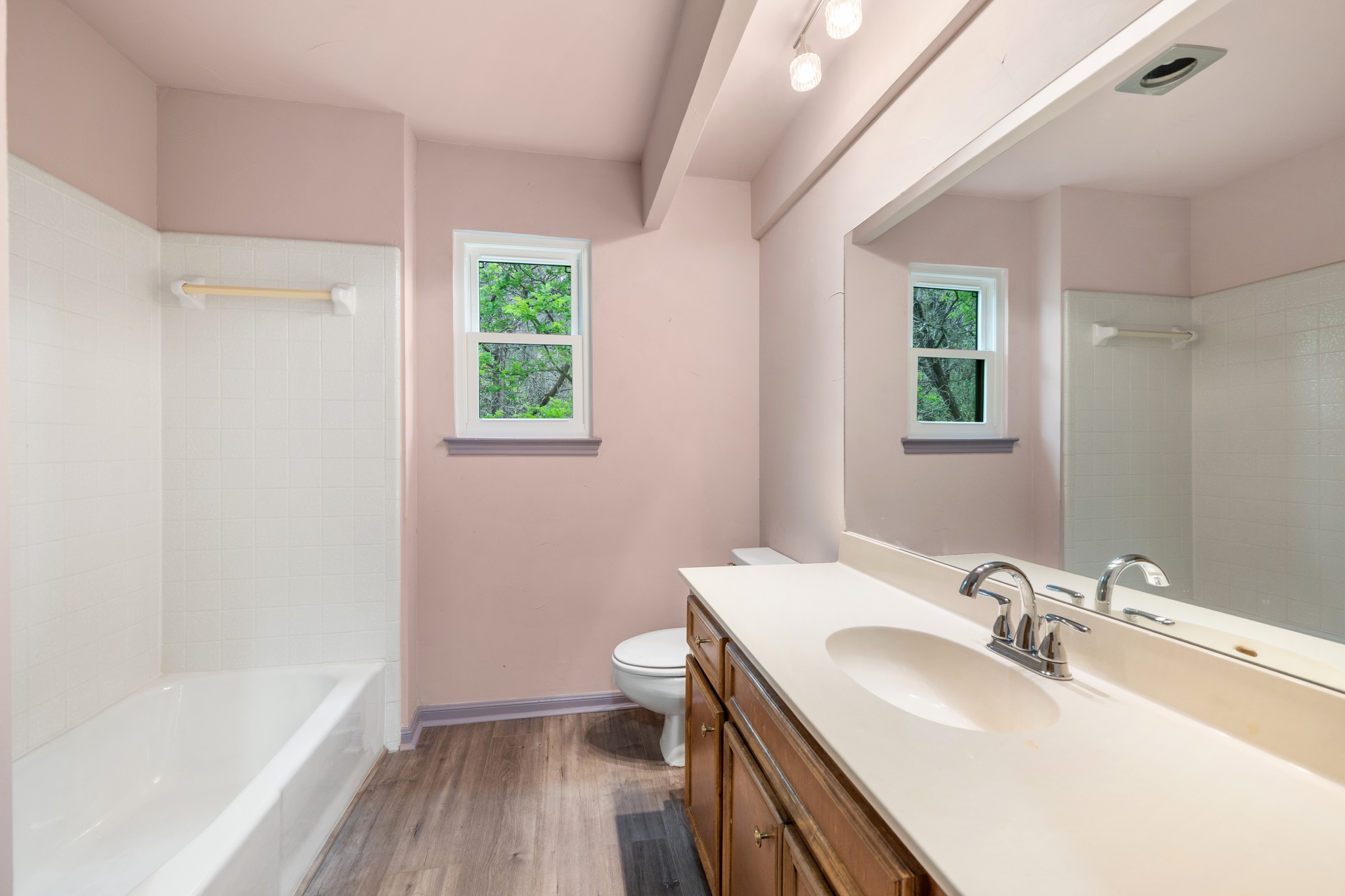 3845 Ranch Road 2222, Unit 19 Austin, TX 78731 - Photo 26 of 38 The full guest bath is located in the hallway, keeping the primary suite completely private