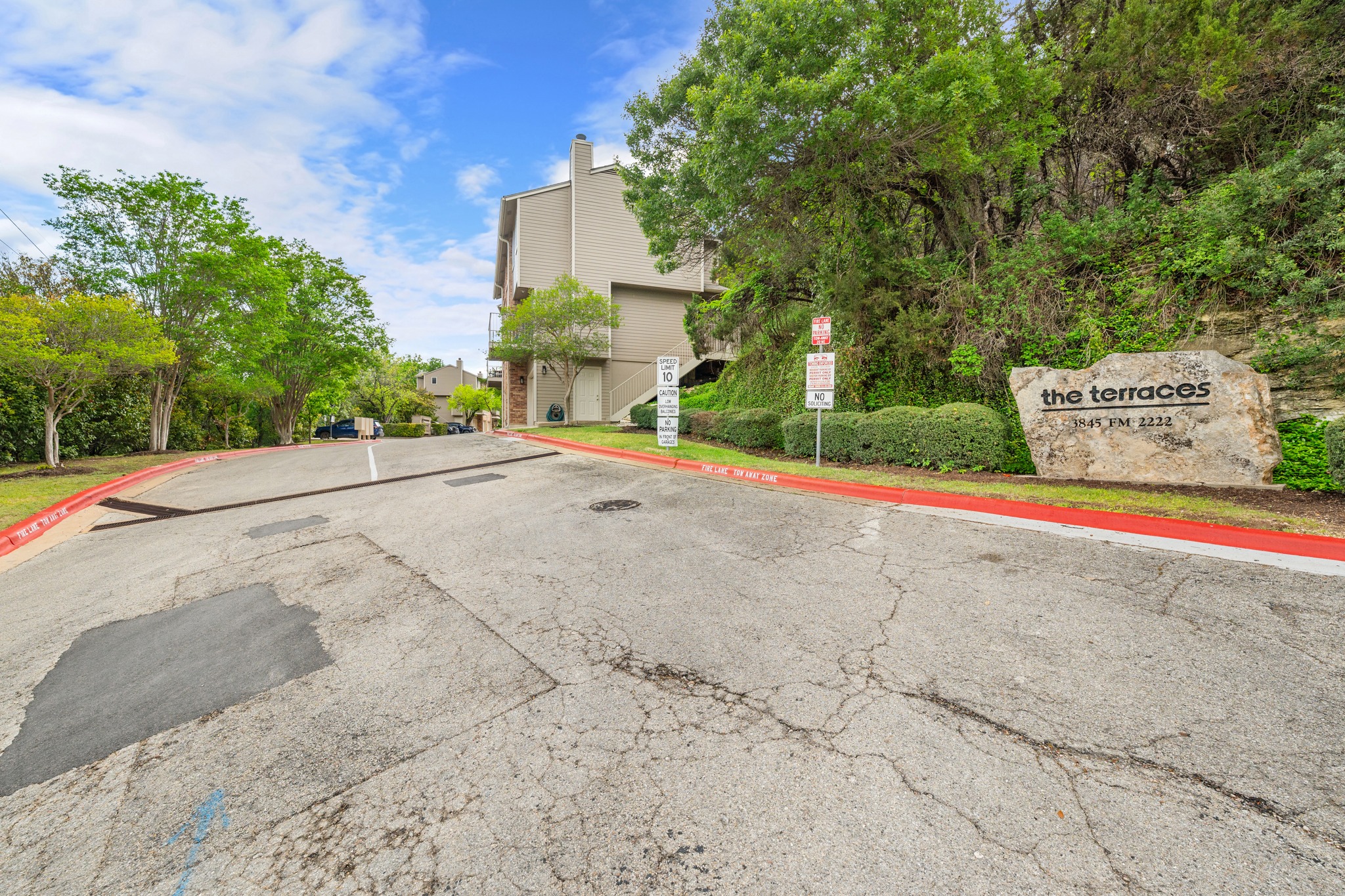 3845 Ranch Road 2222, Unit 19 Austin, TX 78731 - Photo 31 of 38 The community entrance off 2222 provides a clear, easy-to-navigate path home for you and your guests