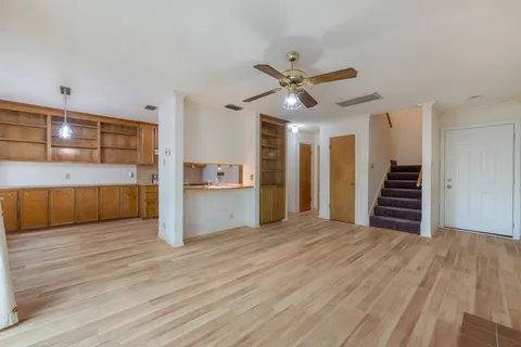 a kitchen with stainless steel appliances granite countertop a refrigerator a stove and a wooden floors