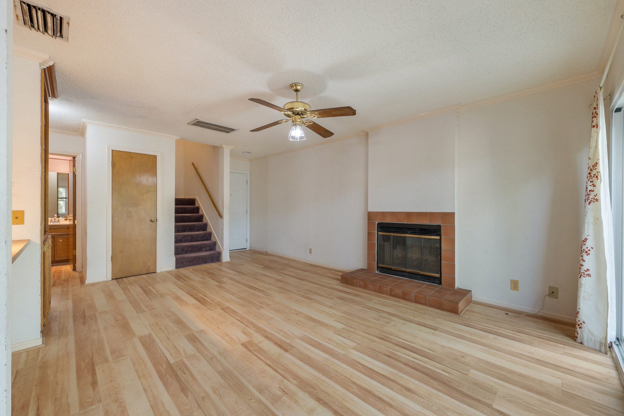 3845 Ranch Road 2222, Unit 19 Austin, TX 78731 - Photo 10 of 38 The fireplace serves as a central focal point for the living area, adding a touch of warmth to the room