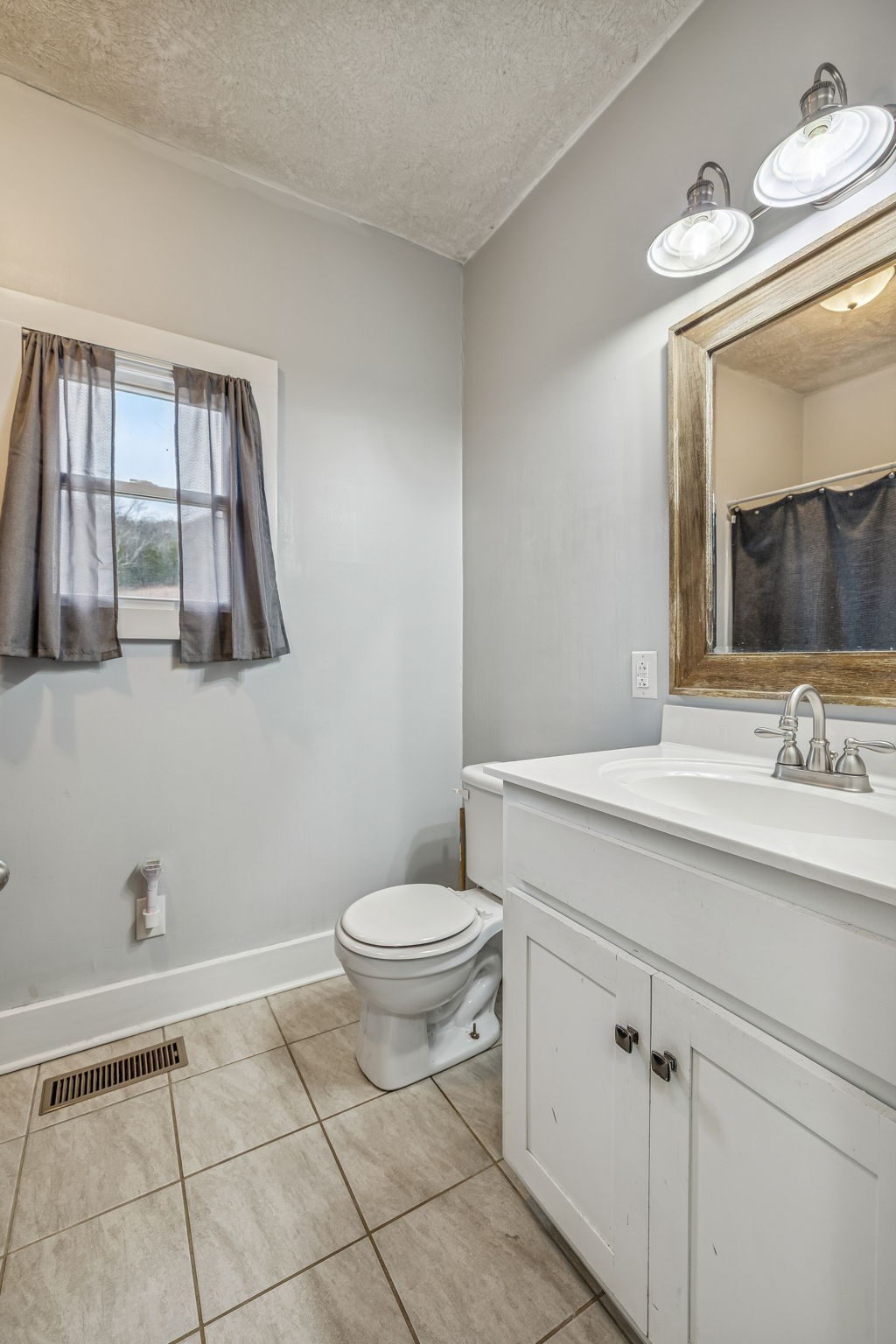 147 Sloan Branch Road Pleasant Shade, TN 37145 - Photo 25 of 53 a bathroom with a toilet sink and mirror