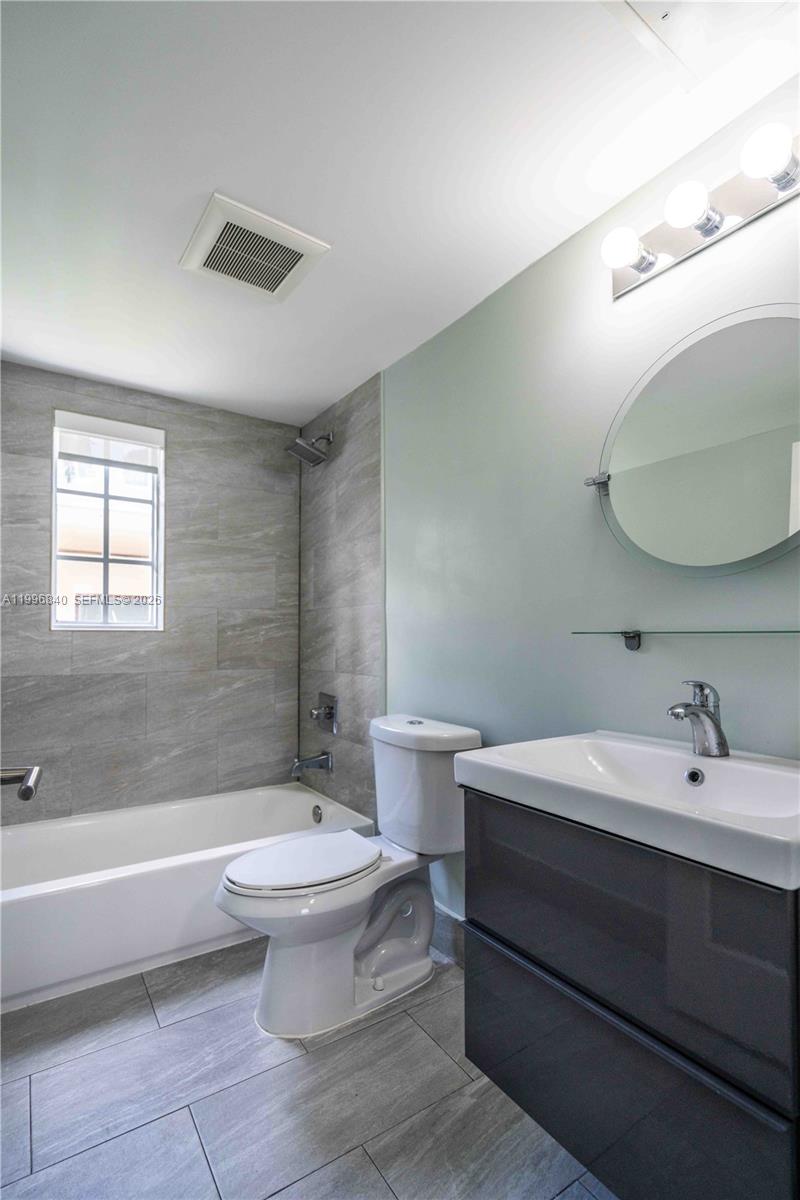 331 85th Street, Unit 17 Miami Beach, FL 33141 - Photo 12 of 16 a bathroom with a sink a toilet and bathtub