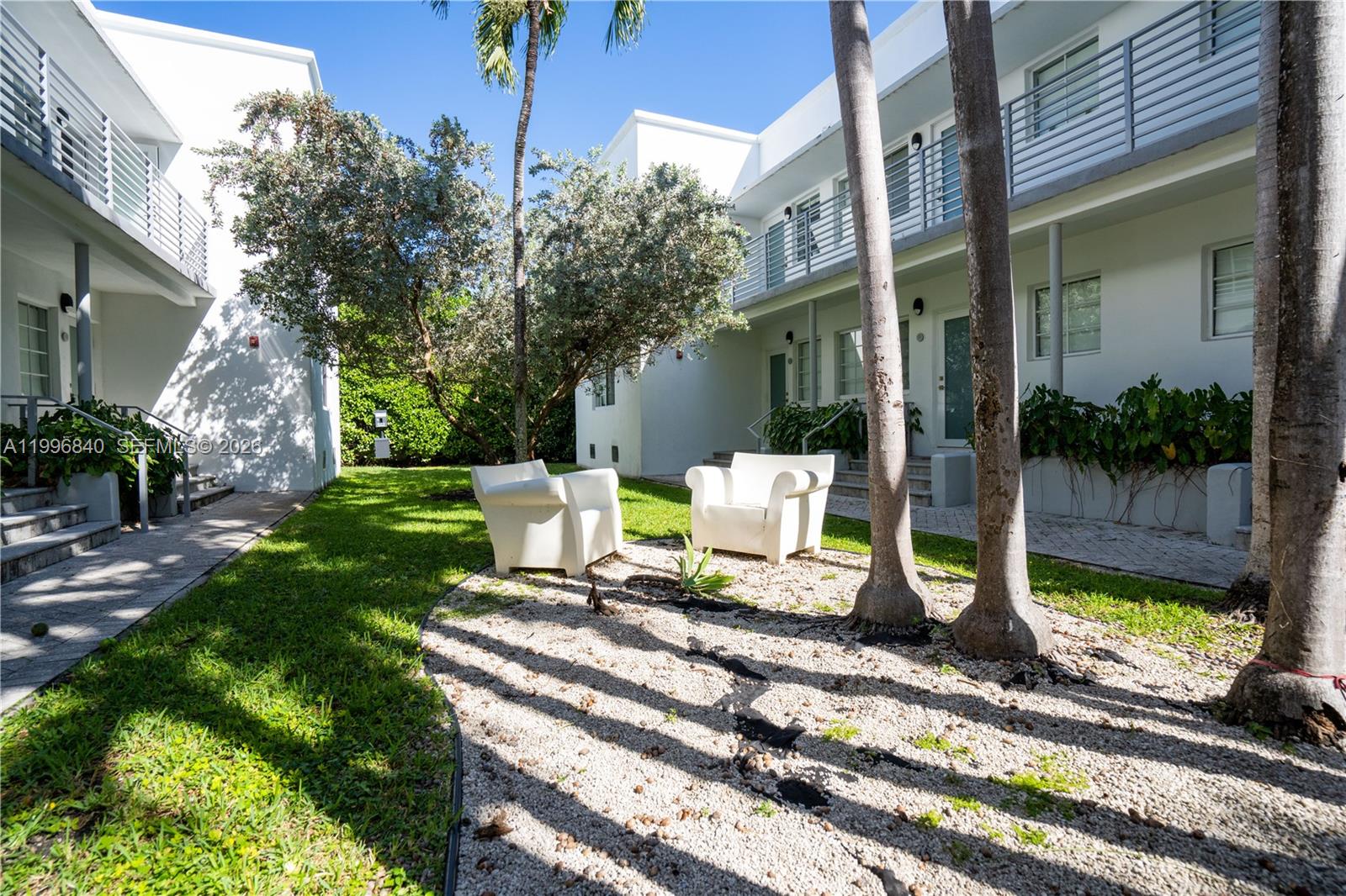 331 85th Street, Unit 17 Miami Beach, FL 33141 - Photo 15 of 16 a view of a chair and tables in the patio
