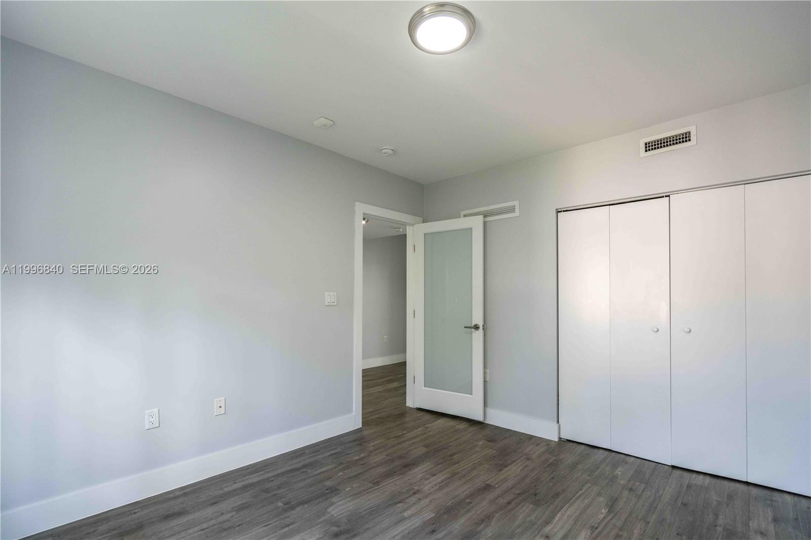331 85th Street, Unit 17 Miami Beach, FL 33141 - Photo 10 of 16 a view of an empty room with wooden floor