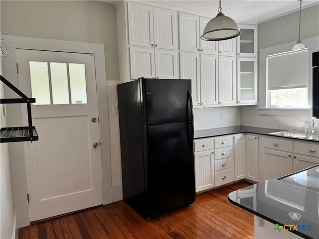 a kitchen with stainless steel appliances a refrigerator and a stove top oven