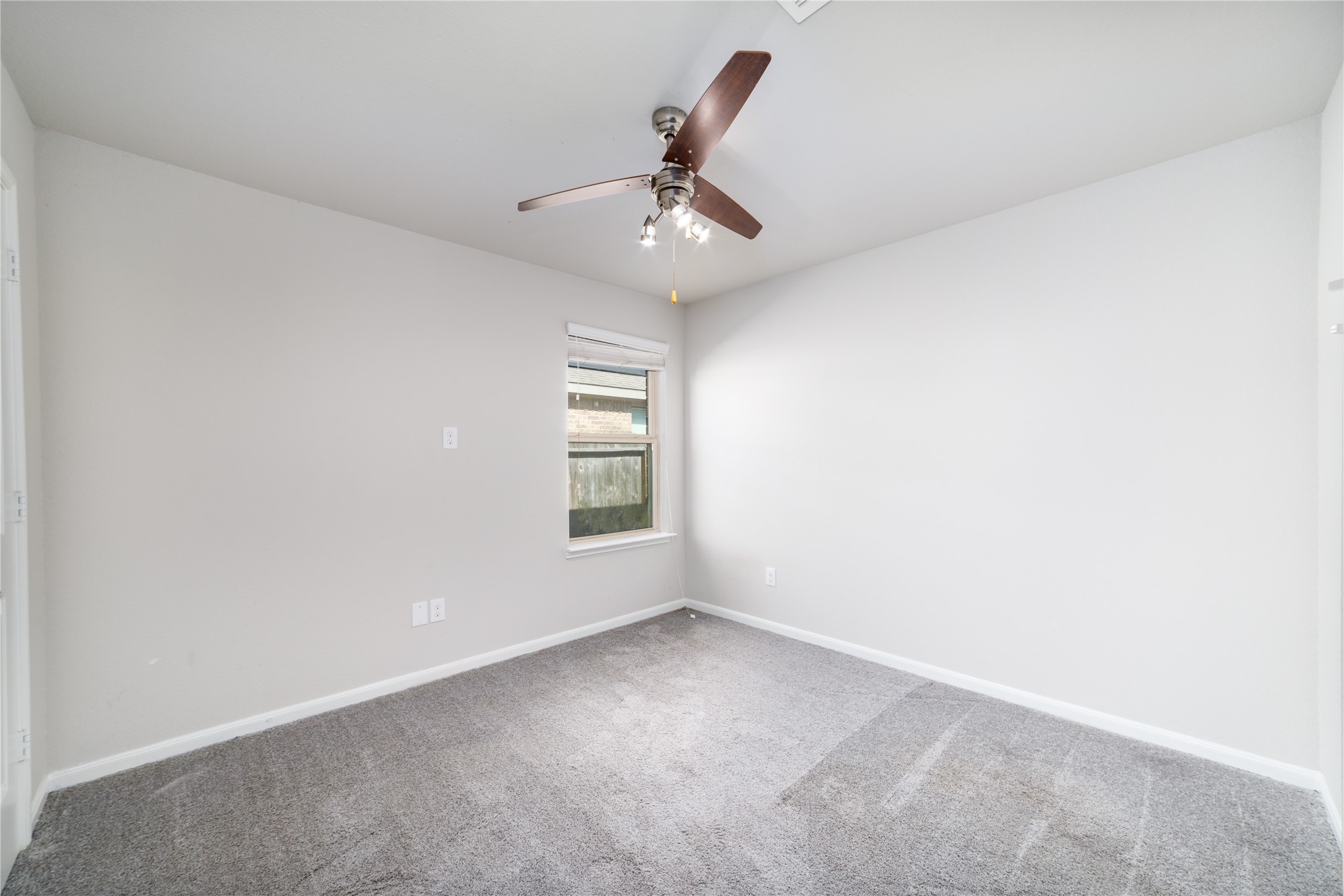 8307 Oakleaf Meadow Court Rosharon, TX 77583 - Photo 25 of 39 an empty room with a window and ceiling fan