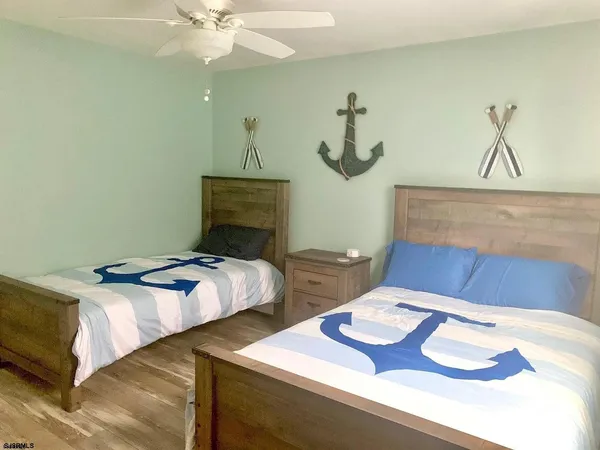 a bedroom with bed and a chandelier