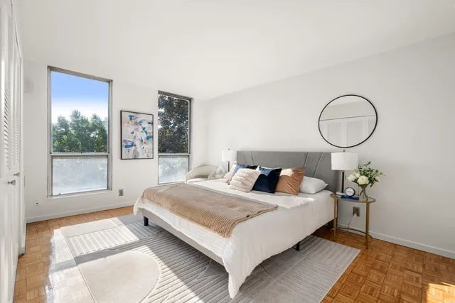 a living room with a bed furniture and a window
