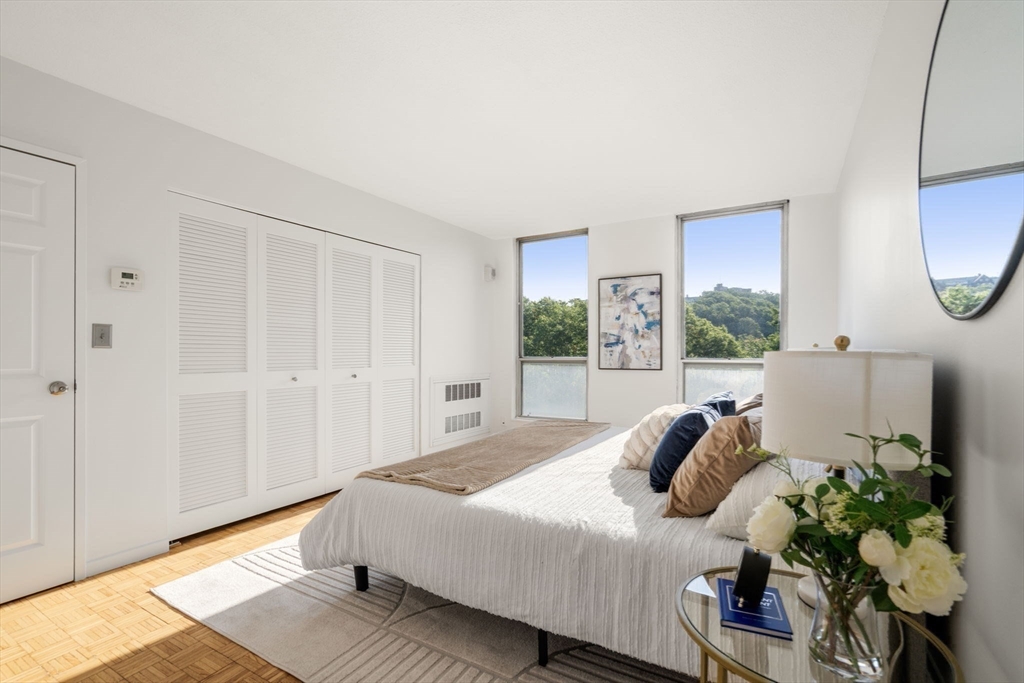 33 Pond Avenue, Unit 523 Brookline, MA 02445 - Photo 13 of 31 a bedroom with a bed potted plant with the window