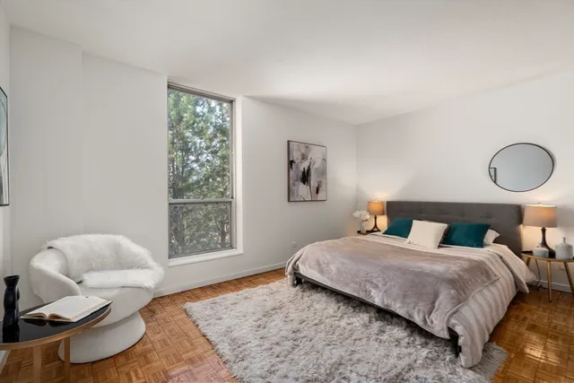 a bedroom with a bed couch and window