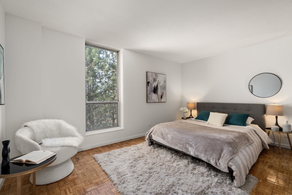 33 Pond Avenue, Unit 523 Brookline, MA 02445 - Photo 15 of 31 a bedroom with a bed couch and window