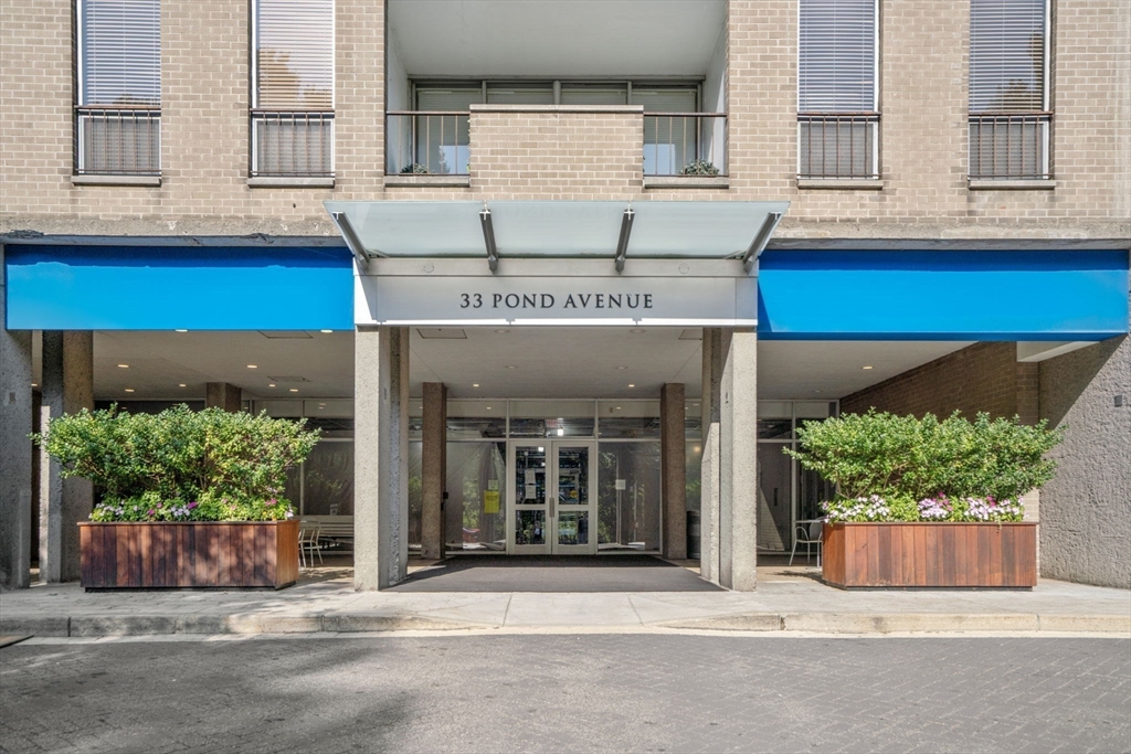 33 Pond Avenue, Unit 523 Brookline, MA 02445 - Photo 3 of 31 a front view of a building with plants
