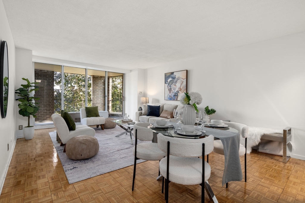33 Pond Avenue, Unit 523 Brookline, MA 02445 - Photo 8 of 31 a living room with furniture and a large window