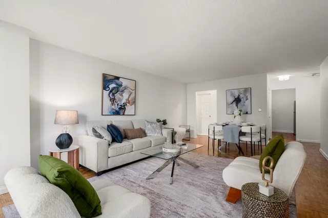 a living room with furniture and wooden floor