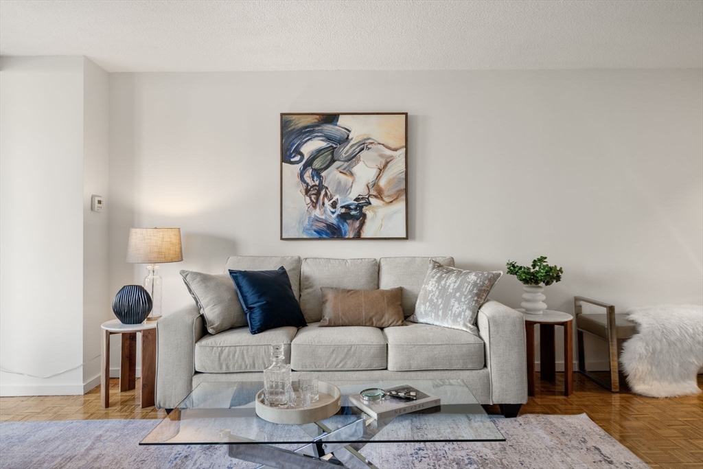 33 Pond Avenue, Unit 523 Brookline, MA 02445 - Photo 10 of 31 a living room with furniture and wooden floor