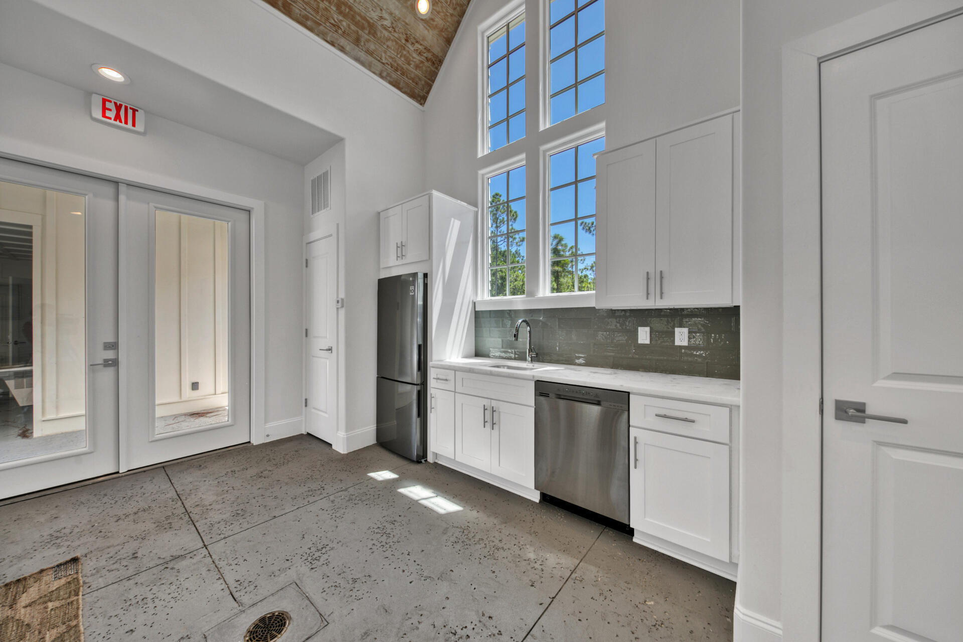 276 Sugar Sands Drive Santa Rosa Beach, FL 32459 - Photo 5 of 16 a kitchen with white cabinets and white appliances