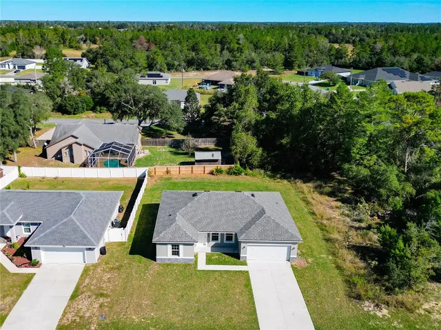 an aerial view of a house with a swimming pool
