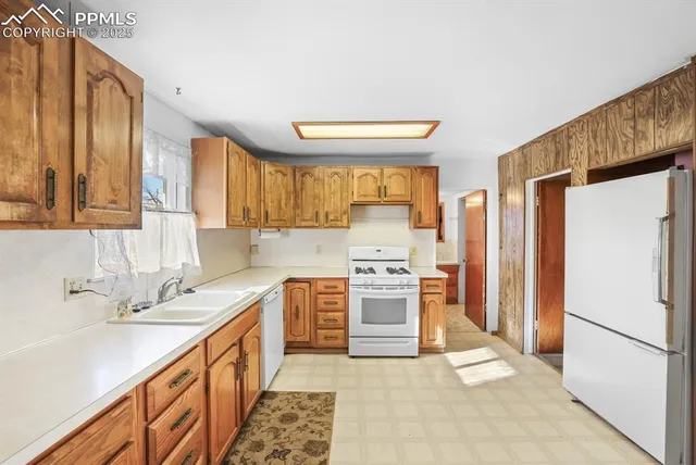 a kitchen with stainless steel appliances a refrigerator sink and stove