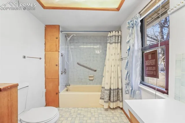 a bathroom with a tub and shower