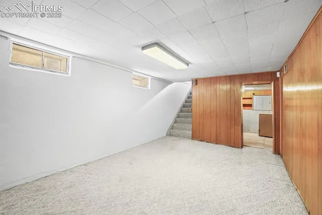 an empty room with furniture and large window