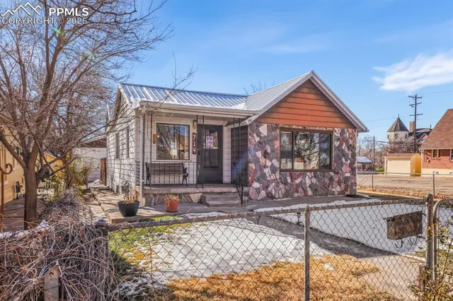 a front view of house with large tree
