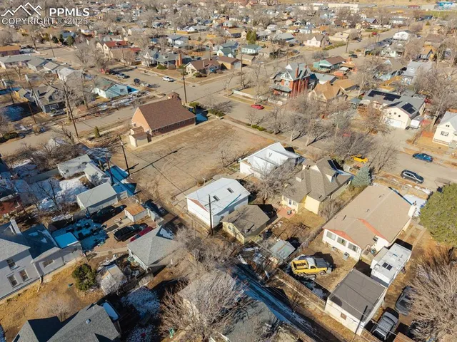 an aerial view of residential houses with outdoor space