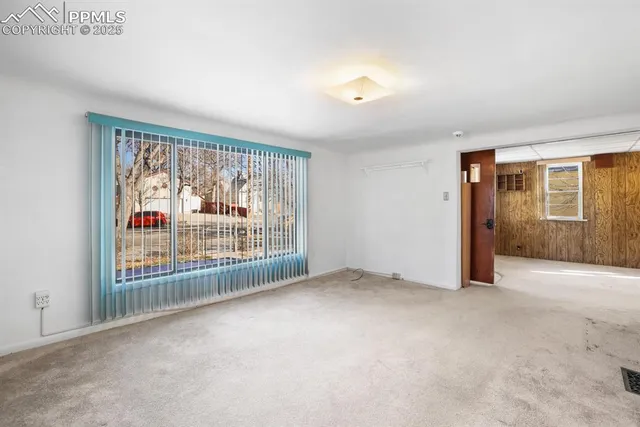 an empty room with floor to ceiling windows