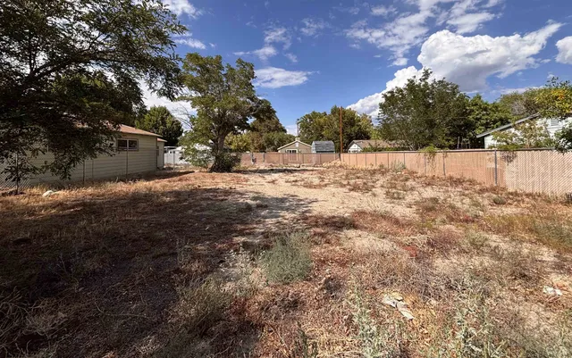 a view of white house with a yard