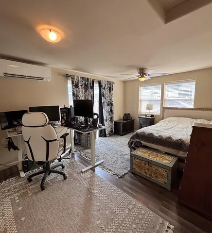 a bedroom with furniture and a window