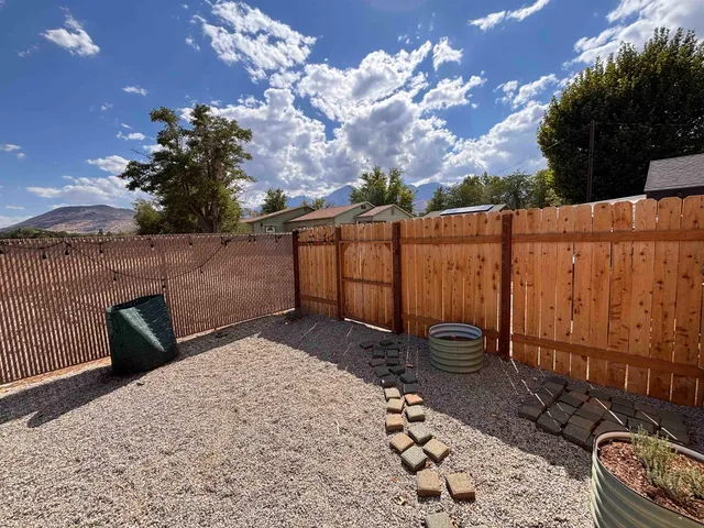 a view of a backyard with sitting area