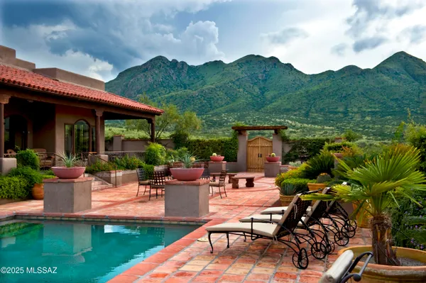 a view of a house with backyard sitting area and garden
