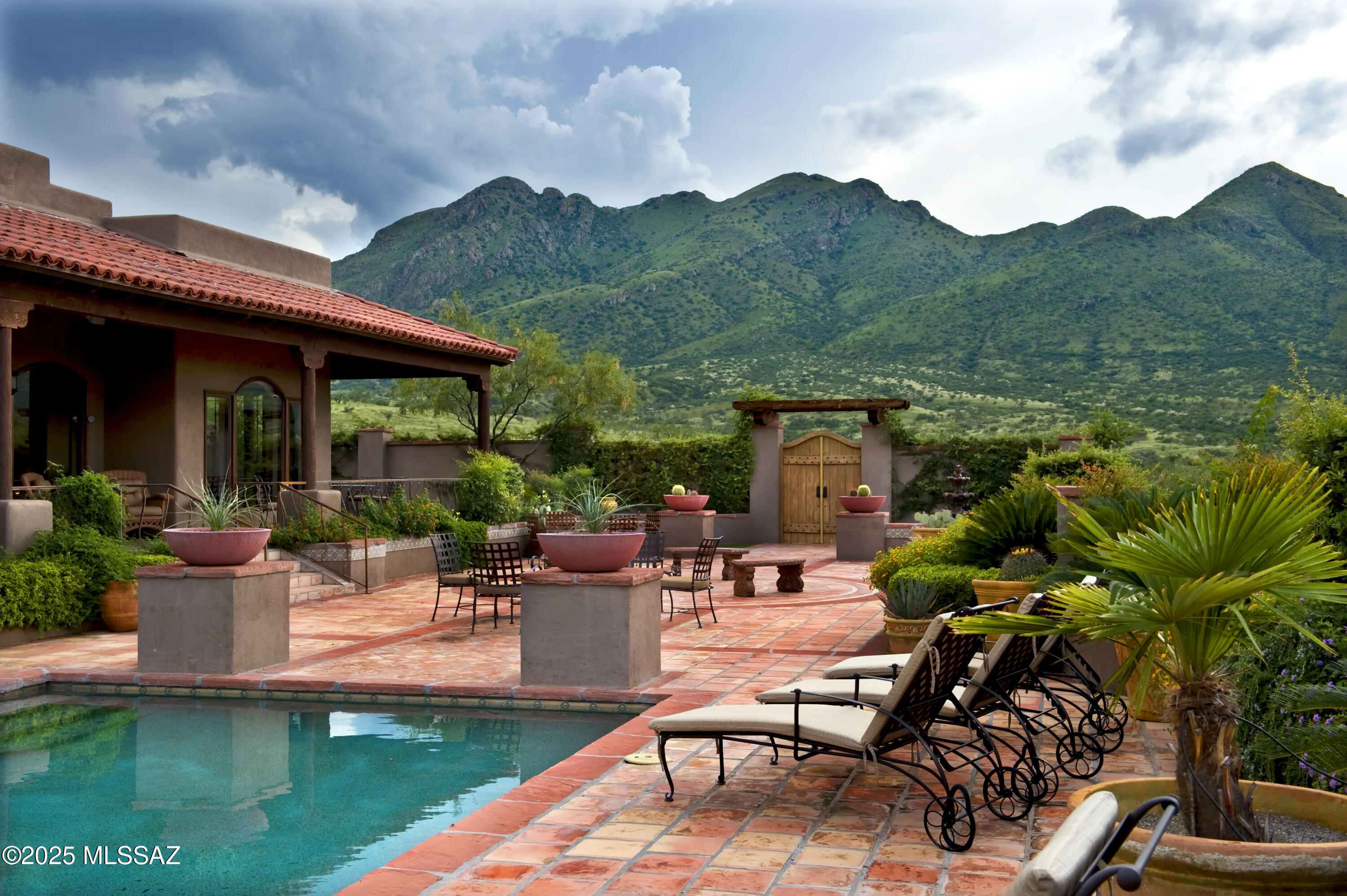 a view of a house with backyard sitting area and garden