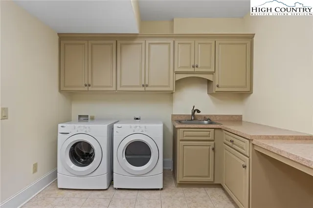 a utility room with sink dryer and washer