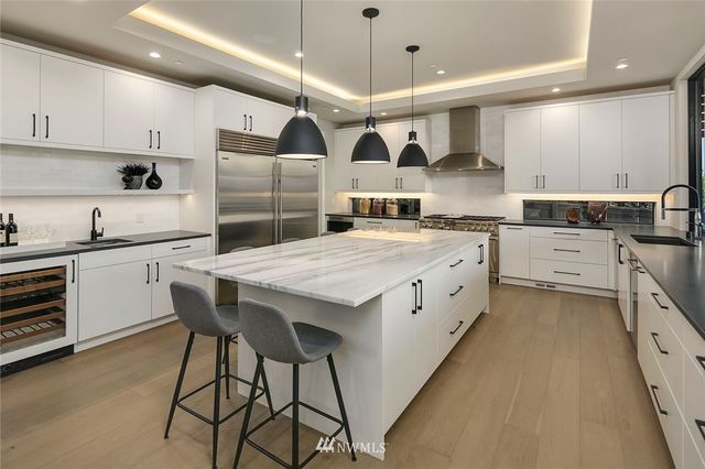 a kitchen with stainless steel appliances kitchen island granite countertop a sink and cabinets