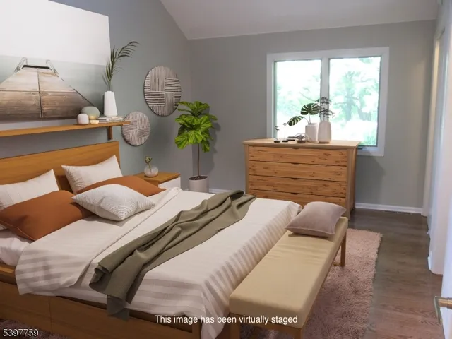 a bedroom with a bed mirror and window