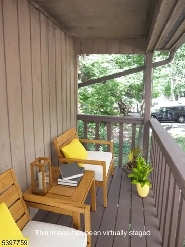 a view of a patio with table and chairs potted plants with wooden floor