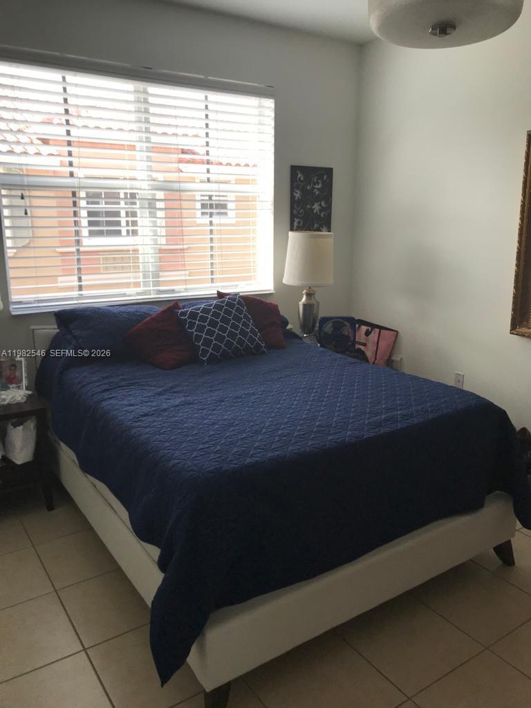 2142 Siena Way Hollywood, FL 33021 - Photo 12 of 13 a bedroom with a bed and a window