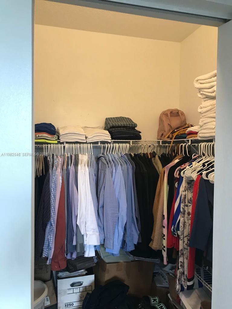 2142 Siena Way Hollywood, FL 33021 - Photo 13 of 13 a view of walk in closet with clothes and shoes