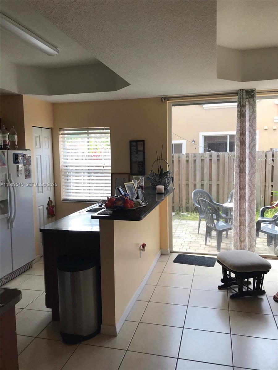 2142 Siena Way Hollywood, FL 33021 - Photo 3 of 13 a kitchen with a sink and living room