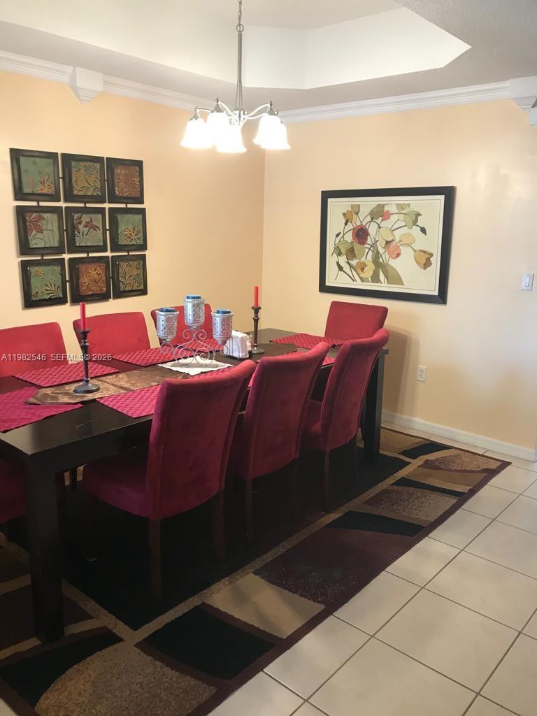 2142 Siena Way Hollywood, FL 33021 - Photo 4 of 13 a bedroom with a bed and a chandelier